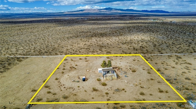 aerial view featuring a desert view and a mountain view