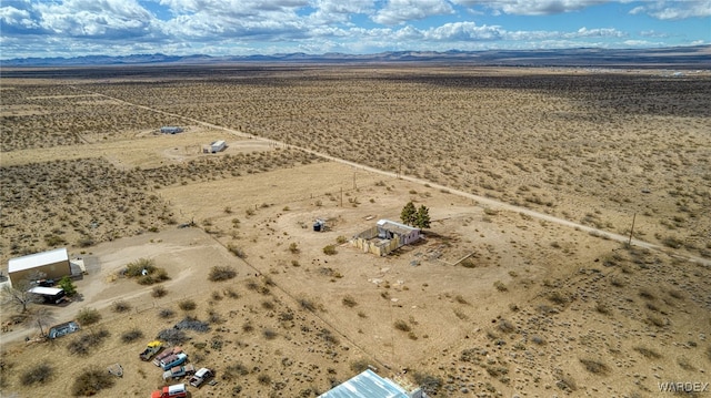 drone / aerial view featuring a mountain view and a desert view