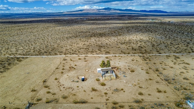 birds eye view of property featuring a mountain view and view of desert