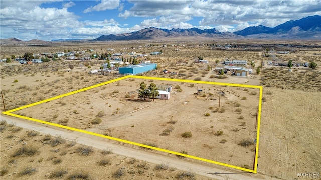 birds eye view of property featuring view of desert, a rural view, and a mountain view