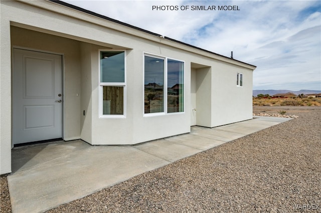 exterior space with a patio area and stucco siding