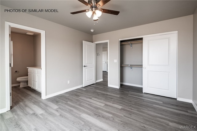 unfurnished bedroom featuring a ceiling fan, a closet, baseboards, connected bathroom, and wood finished floors