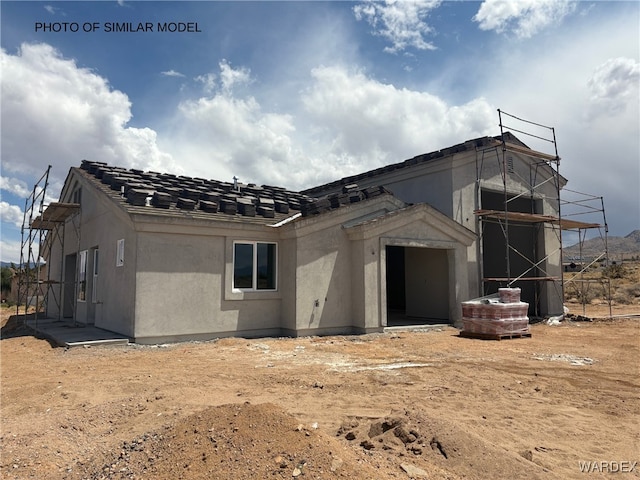 back of property with stucco siding