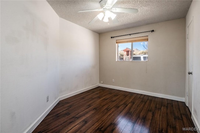 spare room with dark wood-style floors, ceiling fan, a textured ceiling, and baseboards