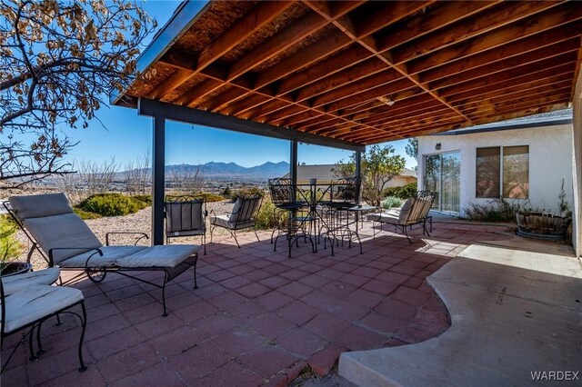 view of patio with a mountain view and outdoor dining area