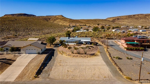 drone / aerial view featuring a residential view and a mountain view