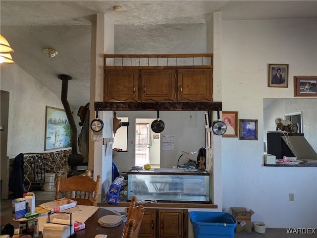 interior space with brown cabinetry and a wood stove