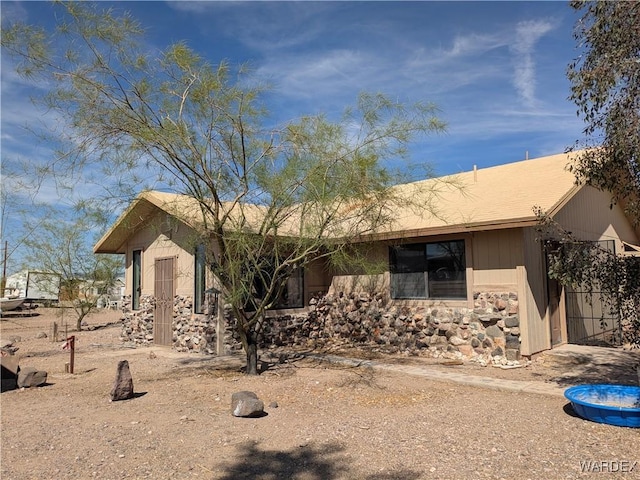ranch-style house with stone siding