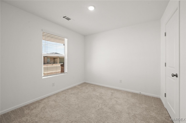 carpeted spare room featuring recessed lighting, visible vents, and baseboards