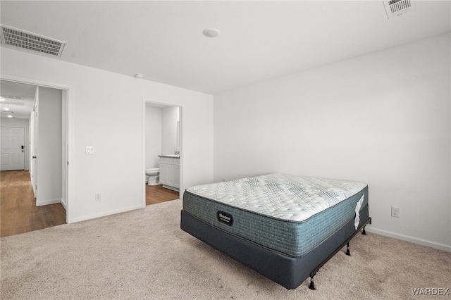 bedroom featuring baseboards, visible vents, and carpet flooring