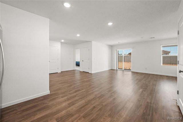 empty room with dark wood-style floors, baseboards, and recessed lighting