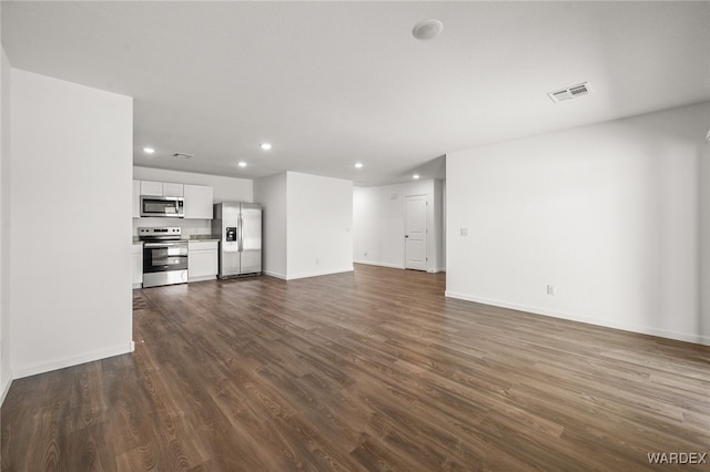 unfurnished living room featuring recessed lighting, visible vents, dark wood finished floors, and baseboards