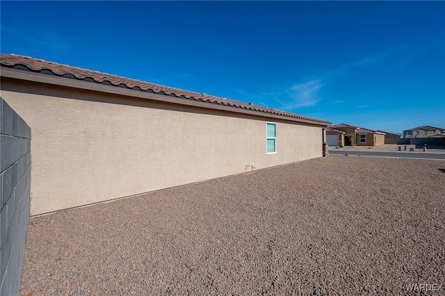 view of side of home featuring stucco siding