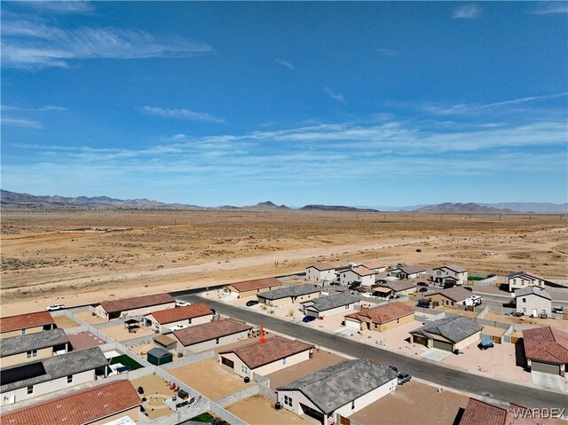 bird's eye view with a residential view, a mountain view, and view of desert