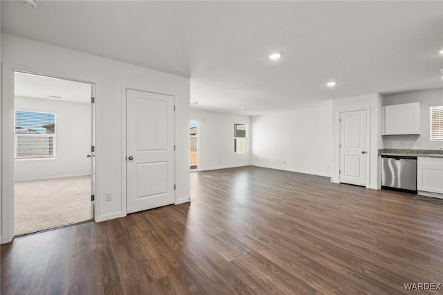 unfurnished living room featuring recessed lighting, dark wood-style flooring, and baseboards