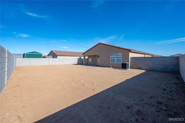 view of yard with central AC unit and a fenced backyard