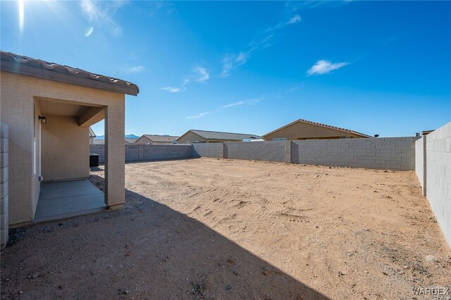 view of yard with a patio area and a fenced backyard