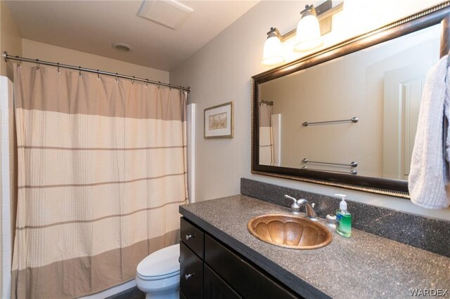 full bathroom with visible vents, vanity, and toilet