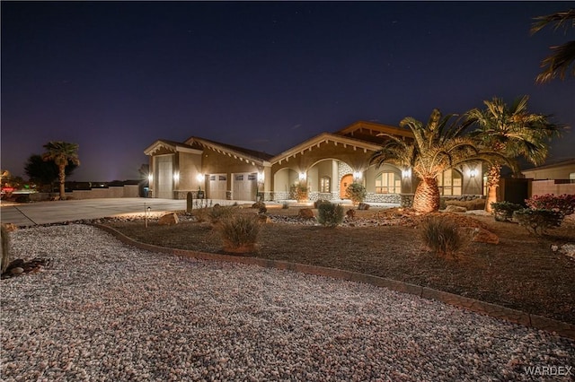 mediterranean / spanish-style home with a garage and concrete driveway