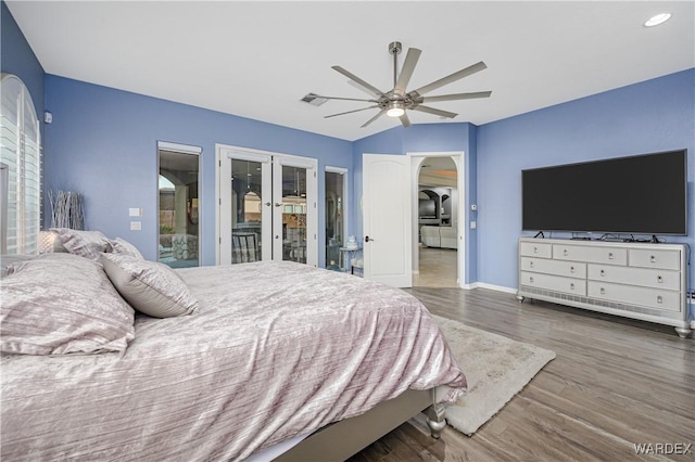 bedroom with lofted ceiling, dark wood-style flooring, visible vents, a ceiling fan, and french doors