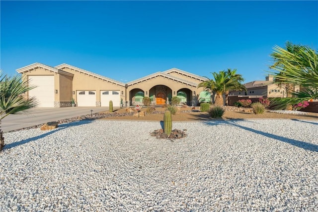 mediterranean / spanish-style home with driveway, an attached garage, and stucco siding