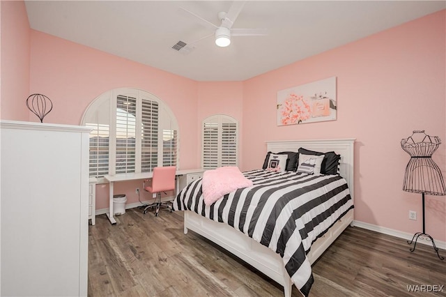 bedroom with baseboards, visible vents, ceiling fan, and wood finished floors