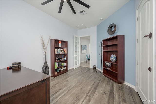 office space with ceiling fan, visible vents, baseboards, french doors, and light wood finished floors