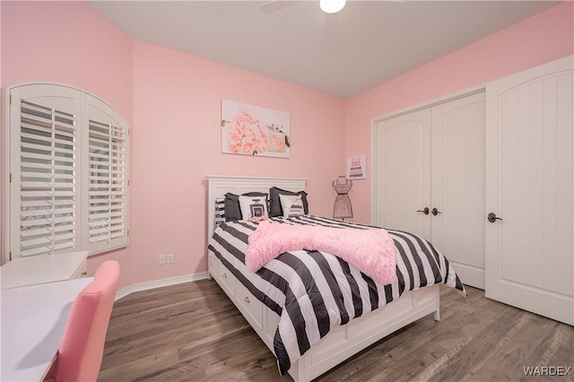 bedroom with baseboards, a closet, a ceiling fan, and wood finished floors