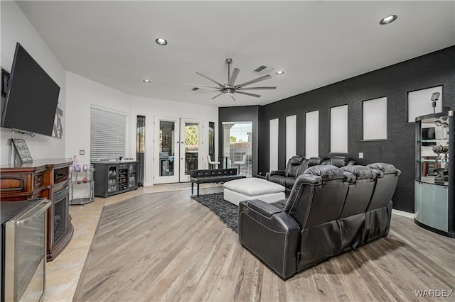 living area featuring recessed lighting, beverage cooler, light wood finished floors, and french doors