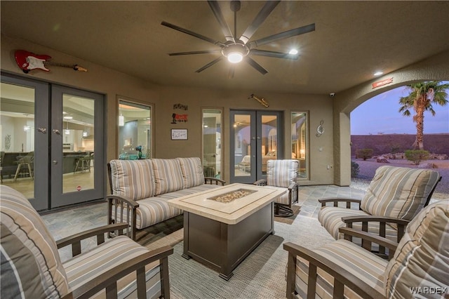 view of patio / terrace featuring french doors and an outdoor living space with a fire pit