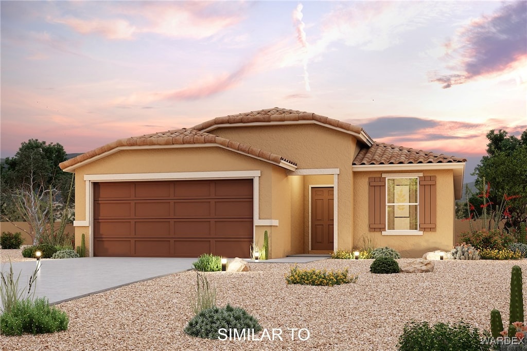 mediterranean / spanish house featuring a garage, concrete driveway, a tiled roof, and stucco siding