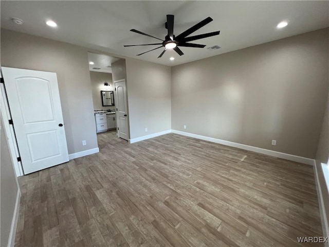 spare room with baseboards, visible vents, a ceiling fan, light wood-type flooring, and recessed lighting