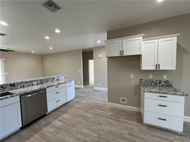 kitchen with visible vents, dishwasher, light stone countertops, light wood-type flooring, and white cabinetry