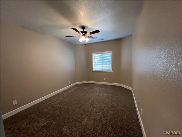 empty room with carpet, visible vents, ceiling fan, and baseboards