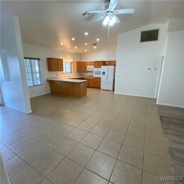 kitchen featuring white appliances, visible vents, brown cabinets, open floor plan, and light countertops