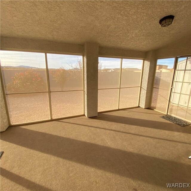 unfurnished sunroom with plenty of natural light