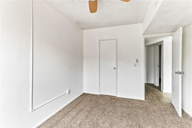 1280 Mohave Dr Unit 28, Bullhead City, AZ 86442 - unfurnished bedroom with a textured ceiling, carpet, baseboards, and a ceiling fan
