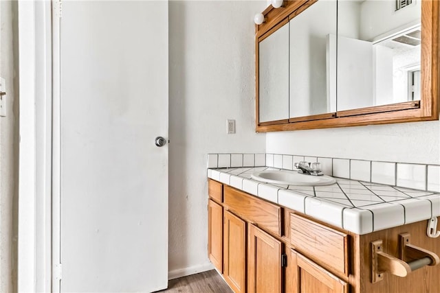 1280 Mohave Dr Unit 28, Bullhead City, AZ 86442 - bathroom with wood finished floors, vanity, and baseboards
