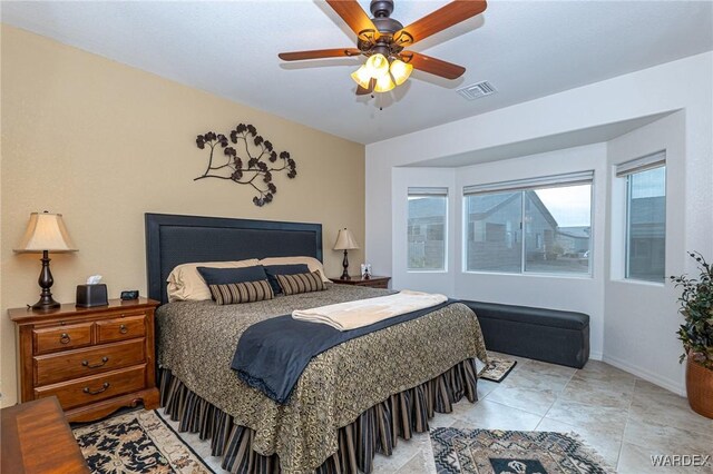 bedroom featuring baseboards, visible vents, and a ceiling fan