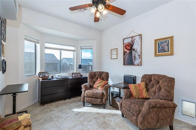 sitting room featuring baseboards and a ceiling fan