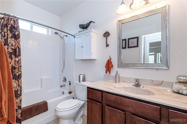 bathroom featuring toilet, shower / tub combo with curtain, and vanity