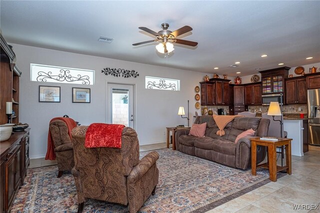 living room with baseboards, visible vents, a ceiling fan, and recessed lighting