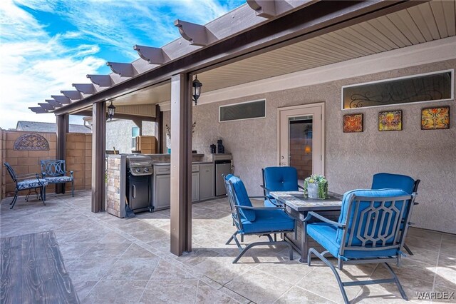 view of patio / terrace with fence, an outdoor kitchen, and outdoor dining space