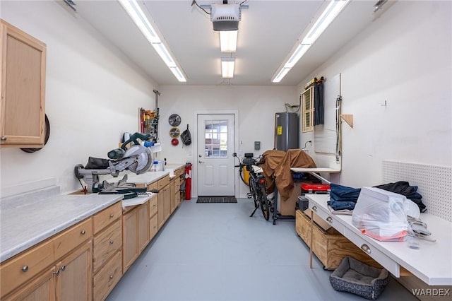 interior space featuring finished concrete floors, light countertops, and water heater