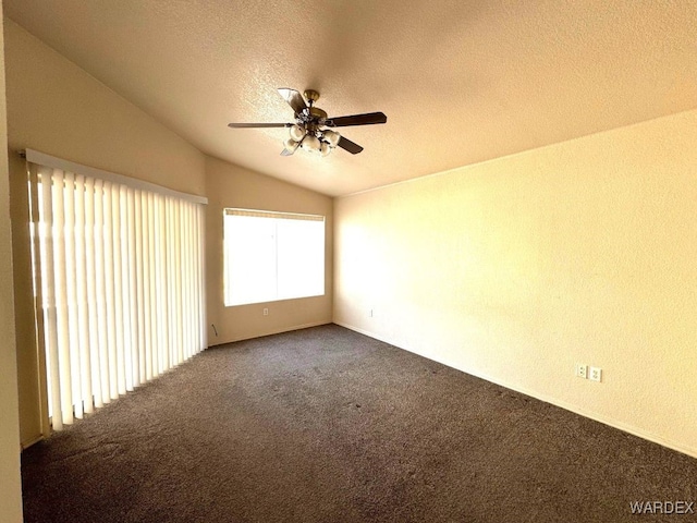 carpeted spare room featuring lofted ceiling, a textured ceiling, and a ceiling fan