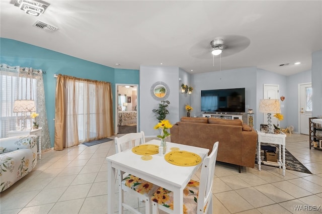 dining room featuring light tile patterned floors, visible vents, and a wealth of natural light