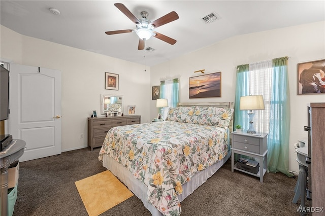 bedroom with ceiling fan, visible vents, and dark carpet