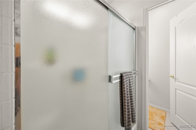 bathroom featuring tile patterned flooring and a shower stall