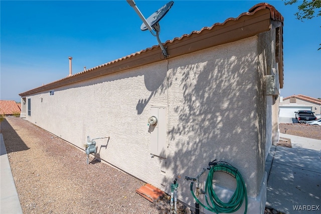 view of side of home with stucco siding