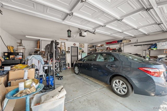 garage featuring a garage door opener and gas water heater